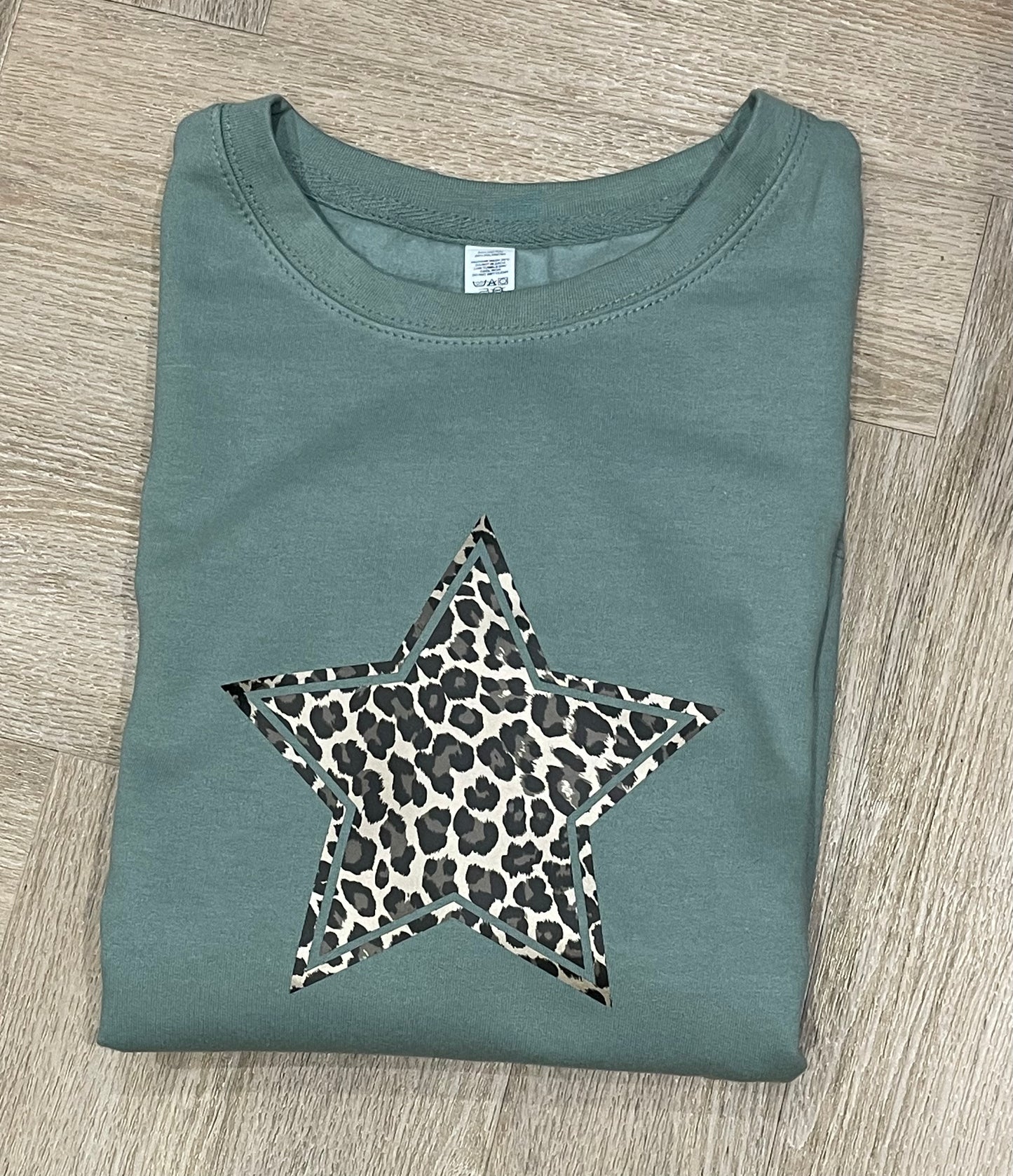 Dusky green sweater with gold leopard print star
